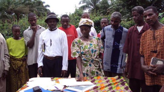 Opens popup gallery with Community leaders signing a land agreement, Rivercess County, Liberia.