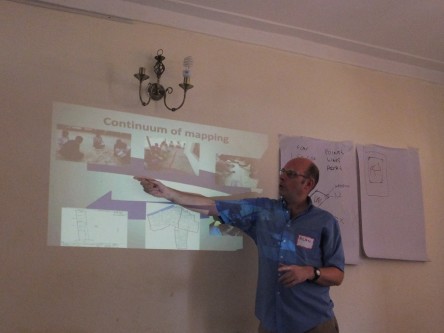 Opens popup gallery with Geographic Information System (GIS) expert Alan Mills explains the continuum of mapping techniques in a training session with LEMU staff