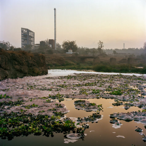 Opens popup gallery with Foam and algae float on water polluted by chemical waste as it enters the Daman River near Vapi from the Common Effluent Treatment Plant, which is operated by the Vapi Industrial Association and monitored by the Gujurat Pollution Control Board.