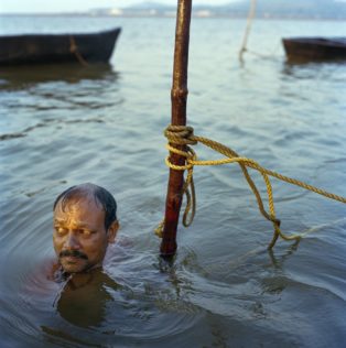 Opens popup gallery with Jaivanth Gouda pauses before diving for clams in the estuary of the Aghanashini River, Karnataka State, India.