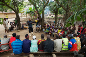 Achmed Sesay, a Namati paralegal, addresses a gathering of villagers in Masethele village, Sierra Leone.