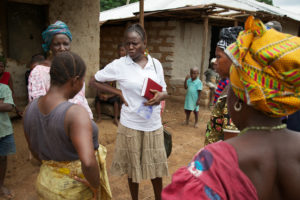 A paralegal speaks with community members in Mamusa community, Sierra Leone. 