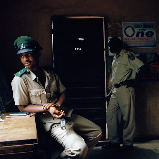 Opens popup gallery with Prison officers in the entrance hall of the Makeni State Prison, Sierra Leone.