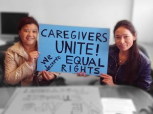 Photo of two women holding sign reading "Caregivers Unite! We deserve Equal Rights"