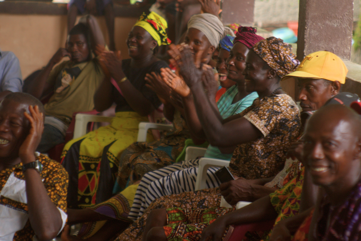 A group of adults sit and cheer.